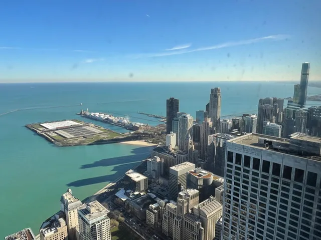 a view of a balcony with dining table and chairs