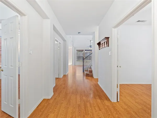 a view of a hallway with wooden floor
