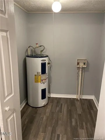 a view of a storage & utility room with refrigerator