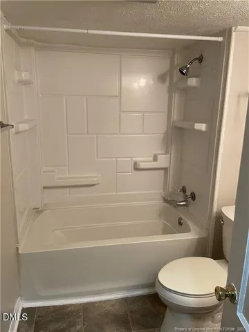 a bathroom with a toilet and a bathtub