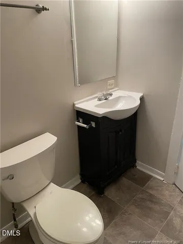 a bathroom with a sink toilet and mirror