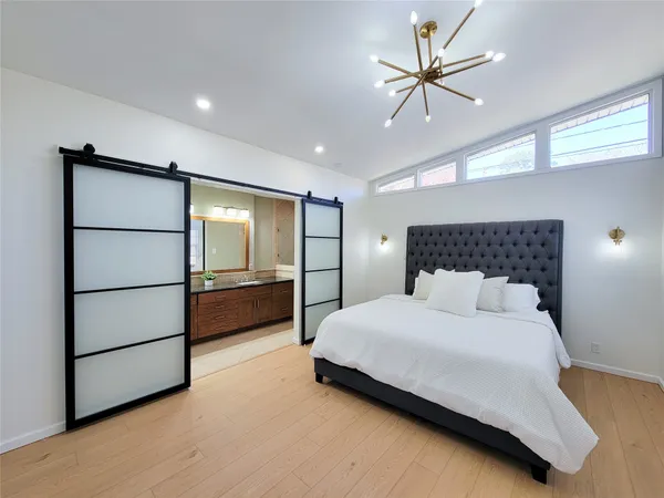a bedroom with a bed and a ceiling fan
