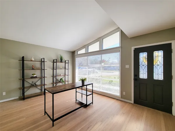 a view of a room with furniture and large windows