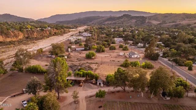 an aerial view of residential house and sandy dunes