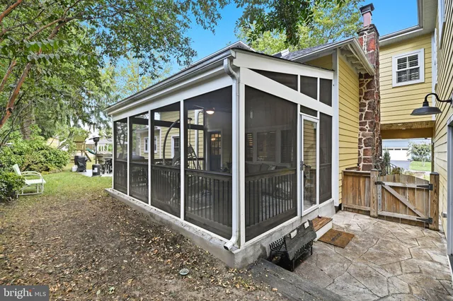 an aerial view of residential house with outdoor space and trees