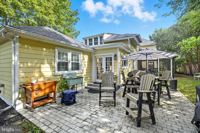 a living room with furniture a chandelier and a dining room