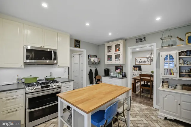 a white bath tub sitting in a bathroom next to a window