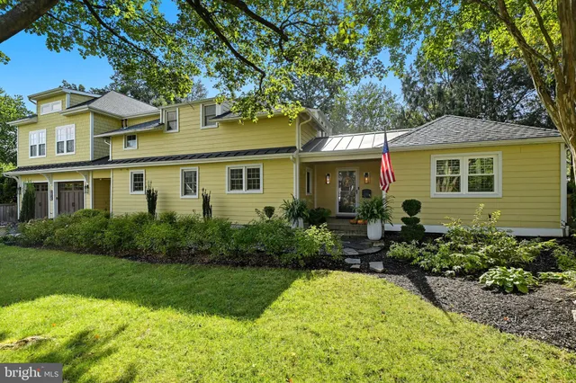 a front view of a house with a yard and outdoor seating