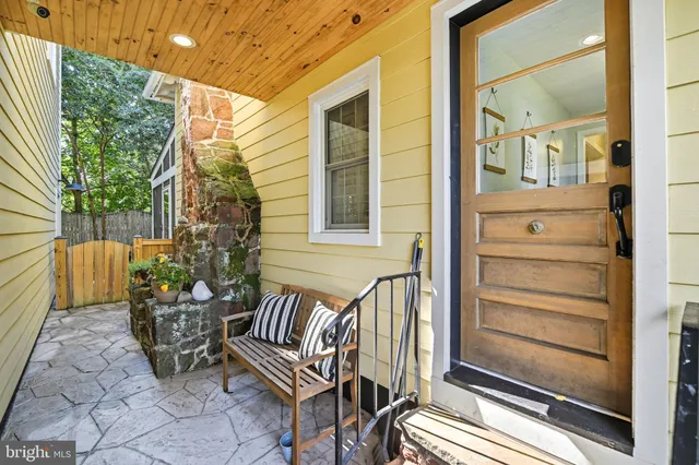 a view of a house with a yard and sitting area