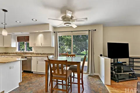 a open kitchen with stainless steel appliances granite countertop a stove and a view of dining room