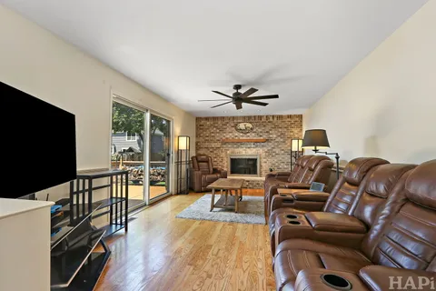 a living room with furniture a flat screen tv and a fireplace