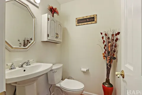 a bathroom with a sink mirror and toilet