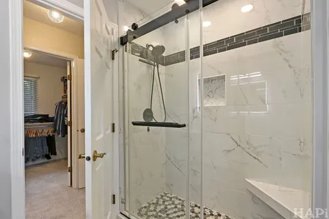 a bathroom with a shower and a glass door