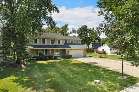 a front view of a house with a yard table and chairs