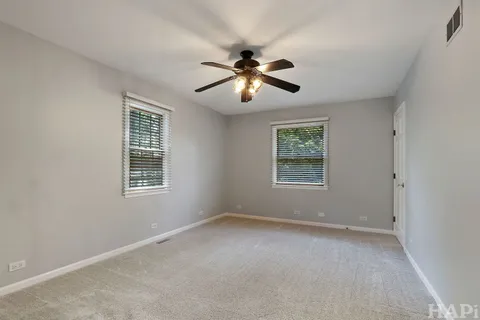 a view of a livingroom with a ceiling fan and window