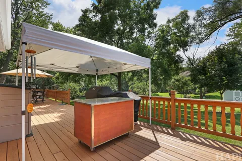 a view of a patio on wooden deck and a backyard