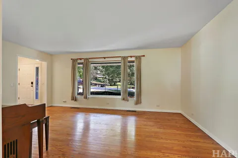 a view of a room with wooden floor and a window