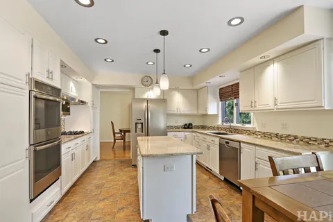 a open kitchen with stainless steel appliances granite countertop a sink stove and refrigerator