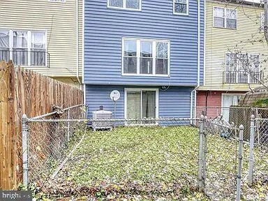 a view of a house with a window and wooden fence