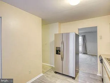 a view of a hallway with wooden cabinets