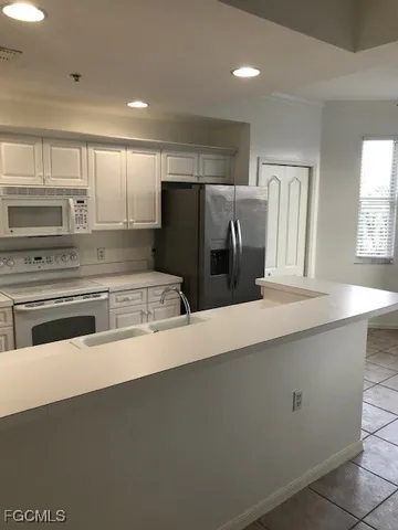 a kitchen with stainless steel appliances a refrigerator and a stove