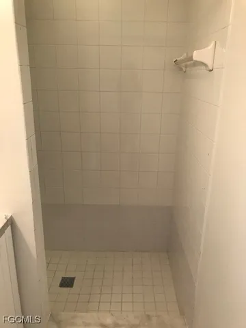 a white toilet sitting next to a shower