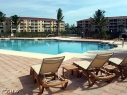 a view of swimming pool with outdoor seating