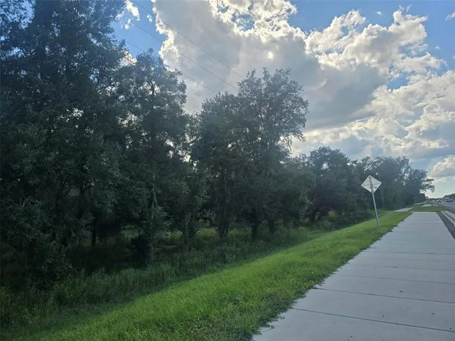 a view of a street with a yard