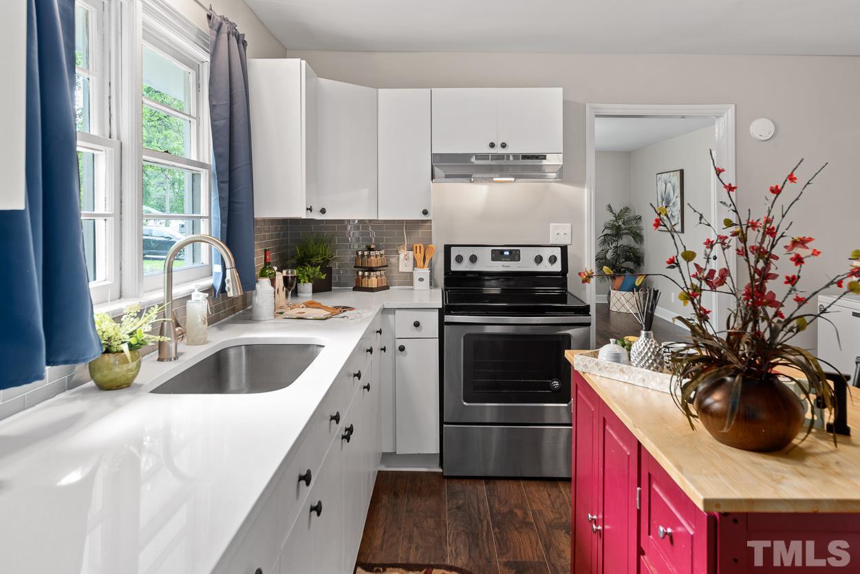 5314 Fayetteville Road Durham, NC 27713 - Photo 11 of 24 a kitchen with a sink stove and cabinets
