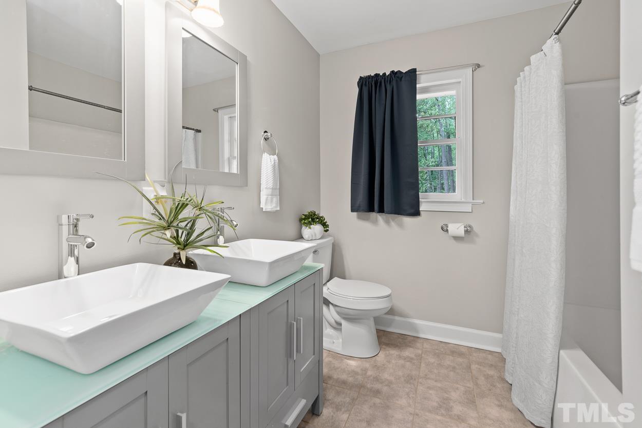 5314 Fayetteville Road Durham, NC 27713 - Photo 14 of 24 a bathroom with a toilet sink and mirror