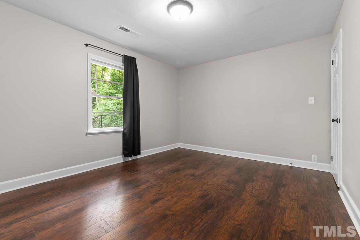 5314 Fayetteville Road Durham, NC 27713 - Photo 15 of 24 an empty room with wooden floor and windows