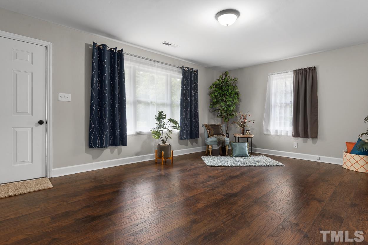 5314 Fayetteville Road Durham, NC 27713 - Photo 3 of 24 a view of an empty room with wooden floor and a window