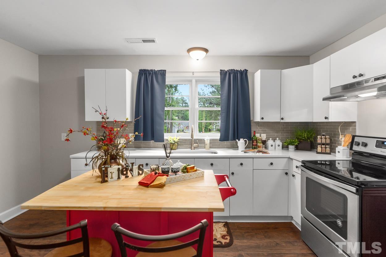 5314 Fayetteville Road Durham, NC 27713 - Photo 7 of 24 a kitchen with a stove a sink and a refrigerator