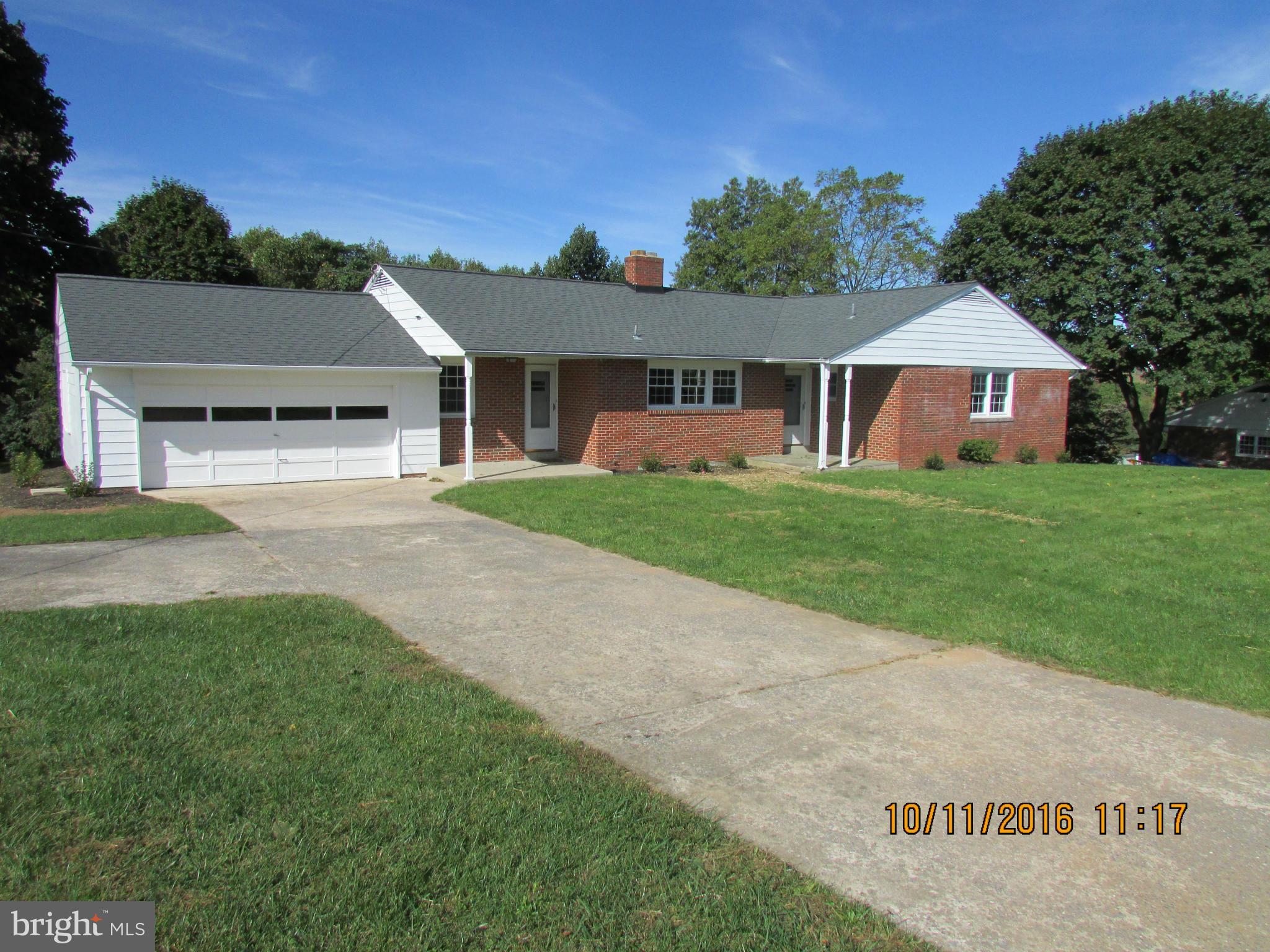 a view of a house with a yard and tree s