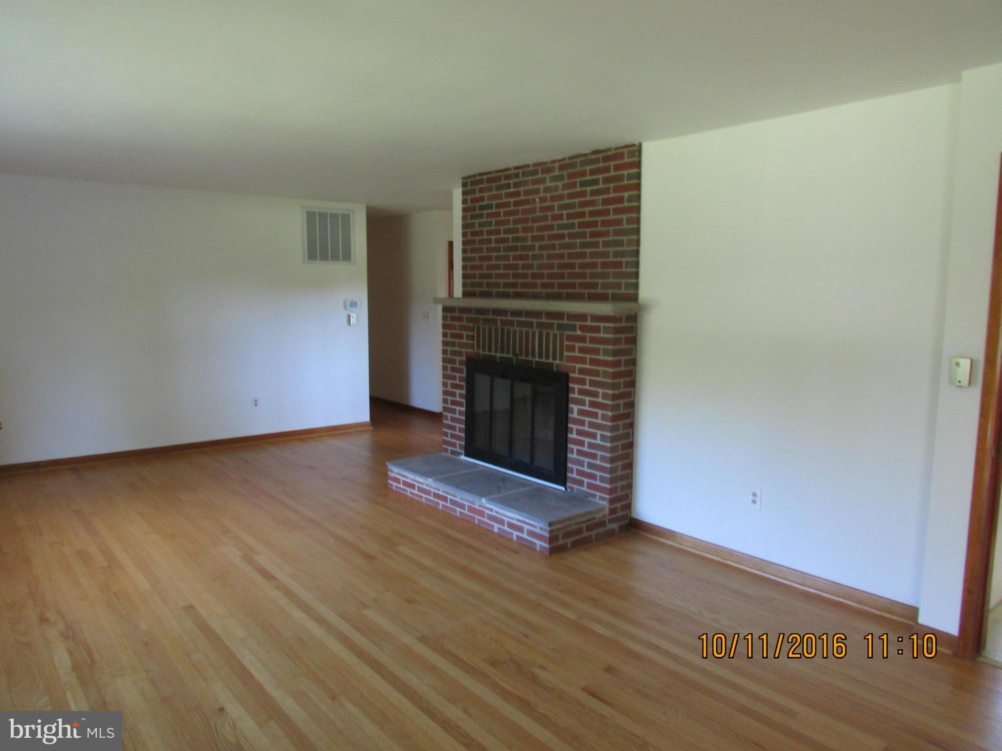 9250 Brown Church Road Mount Airy, MD 21771 - Photo 8 of 23 a view of a livingroom with wooden floor and a fireplace