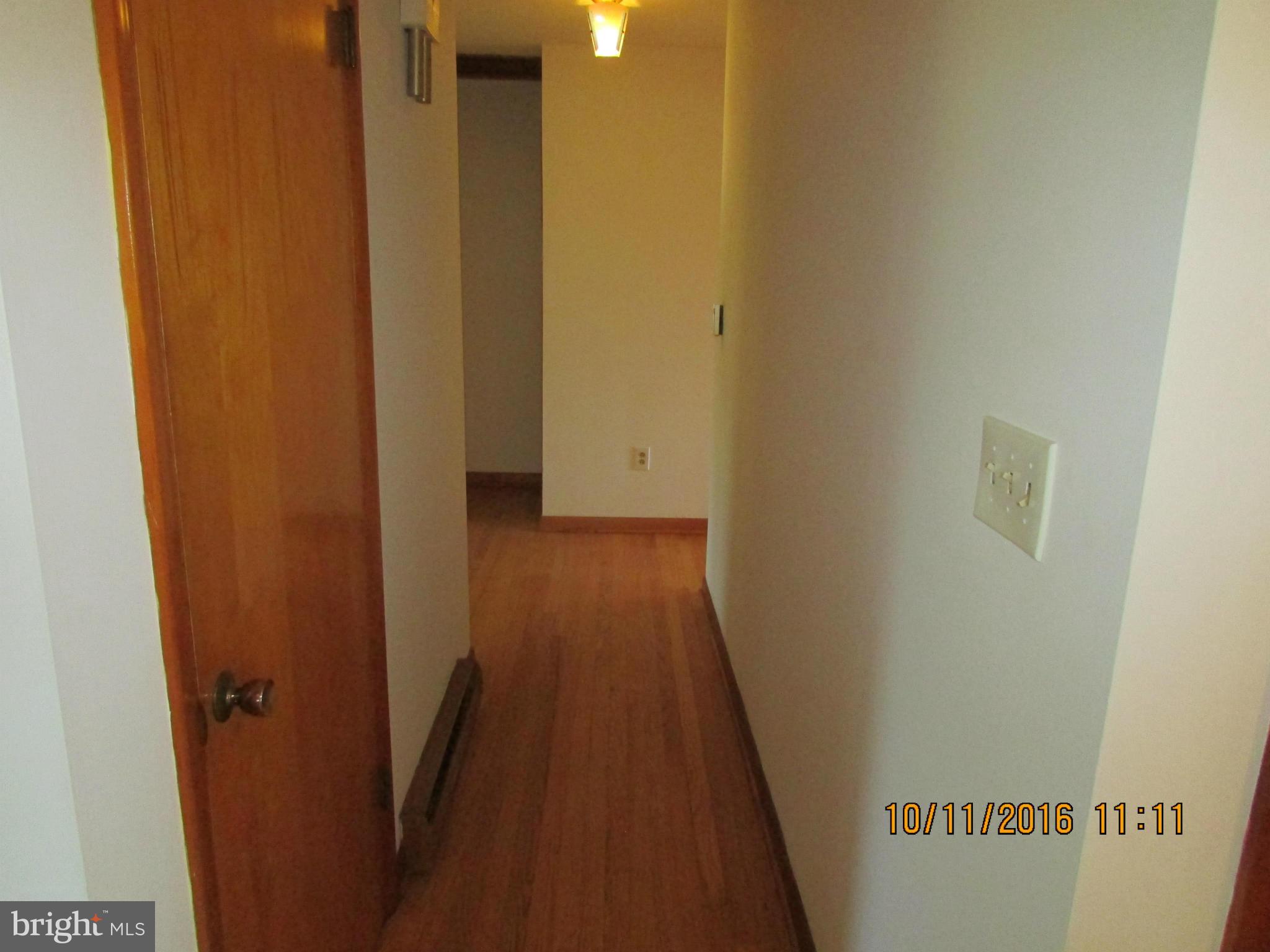 9250 Brown Church Road Mount Airy, MD 21771 - Photo 10 of 23 a view of a hallway with wooden floor