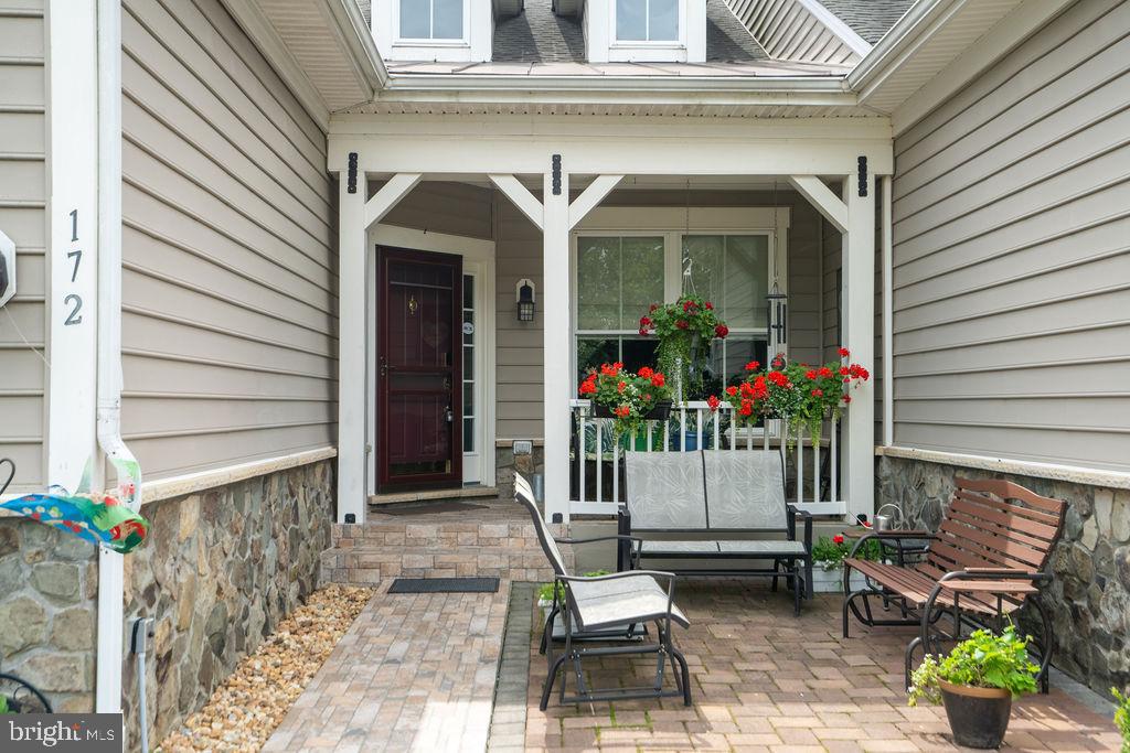 172 Ruffed Grouse Court White Post, VA 22663 - Photo 5 of 62 a front view of a house with outdoor seating and a potted plant