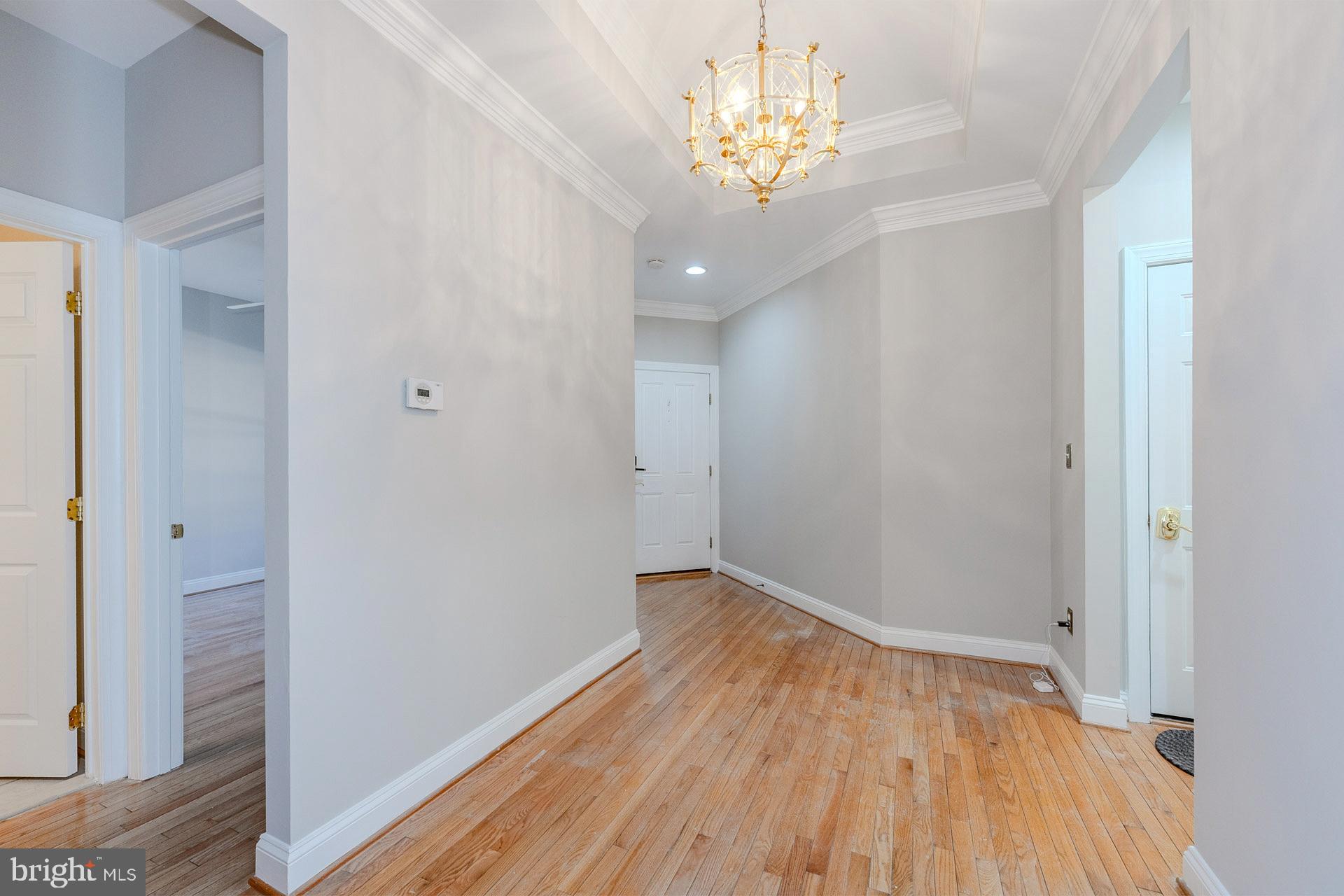 172 Ruffed Grouse Court White Post, VA 22663 - Photo 10 of 62 a view of empty room with wooden floor and chandelier