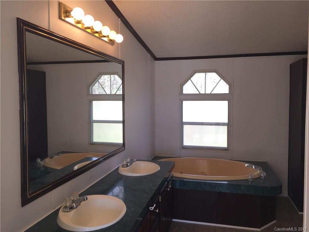 136 Morrison Road Mocksville, NC 27028 - Photo 12 of 14 a bathroom with a sink and a mirror