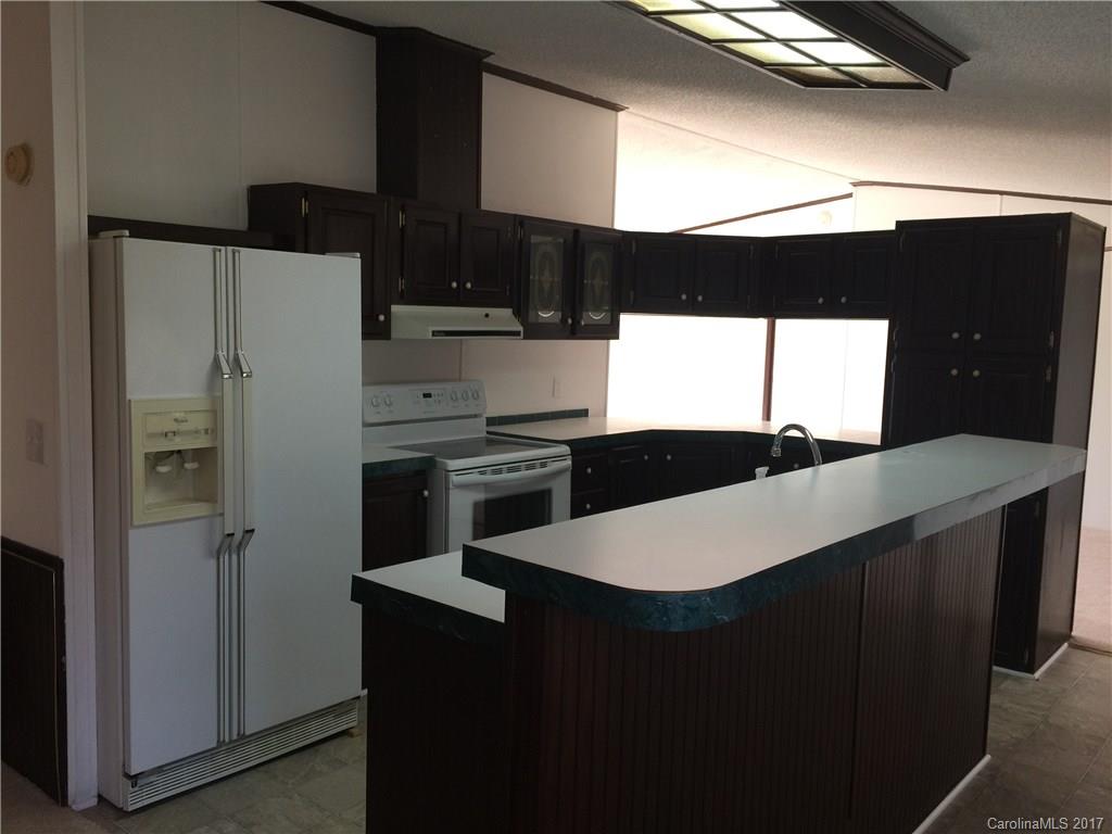 136 Morrison Road Mocksville, NC 27028 - Photo 5 of 14 a kitchen with stainless steel appliances a refrigerator a sink and white cabinets
