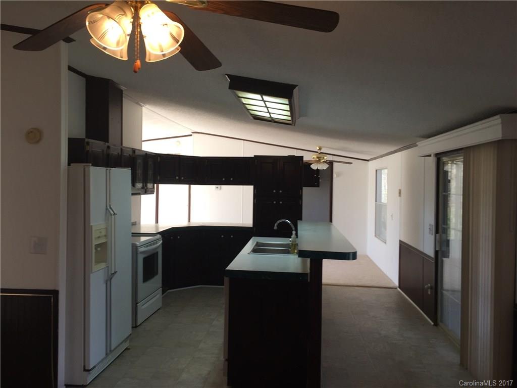 136 Morrison Road Mocksville, NC 27028 - Photo 6 of 14 a kitchen with stainless steel appliances kitchen island granite countertop a refrigerator a stove and a sink