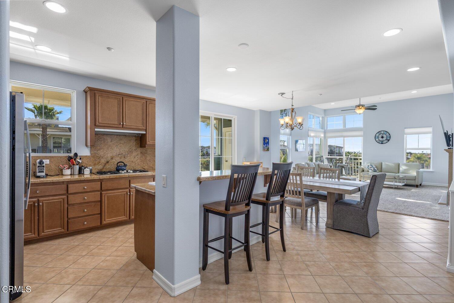 1481 Windshore Way Oxnard, CA 93035 - Photo 14 of 31 a view of a dining room with furniture and a kitchen