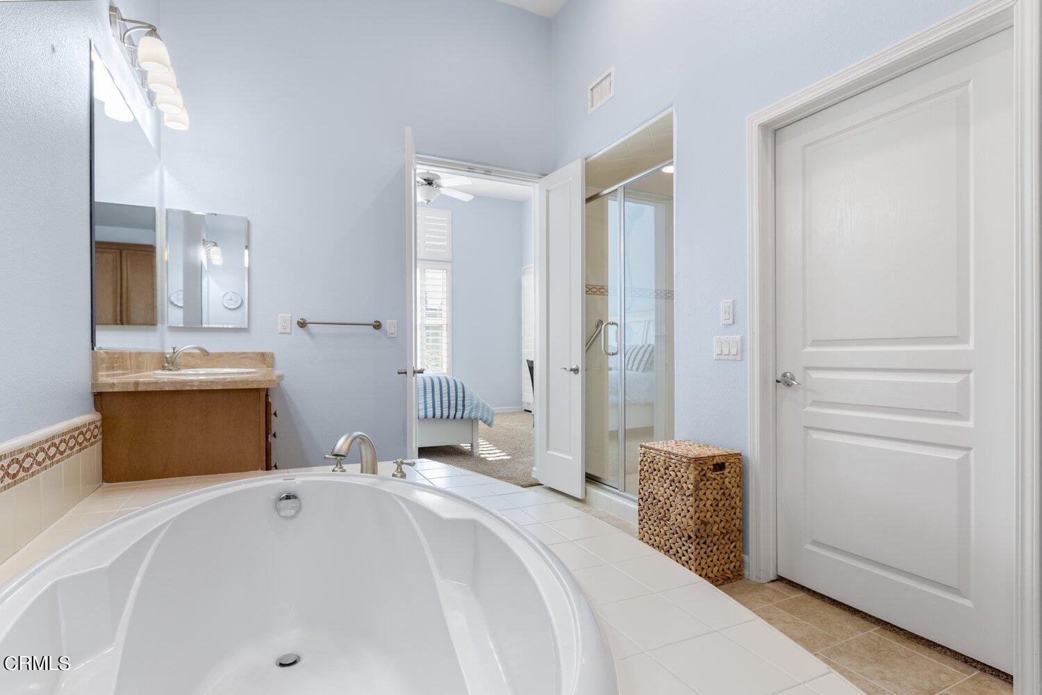 1481 Windshore Way Oxnard, CA 93035 - Photo 18 of 31 a en suite bathroom with a tub sink and mirror