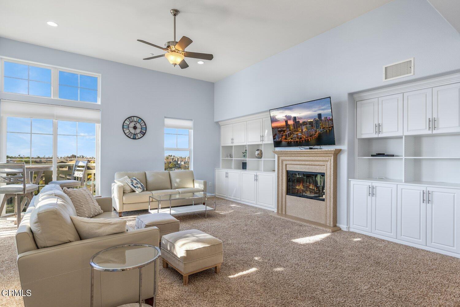 1481 Windshore Way Oxnard, CA 93035 - Photo 7 of 31 a living room with furniture a flat screen tv and a fireplace