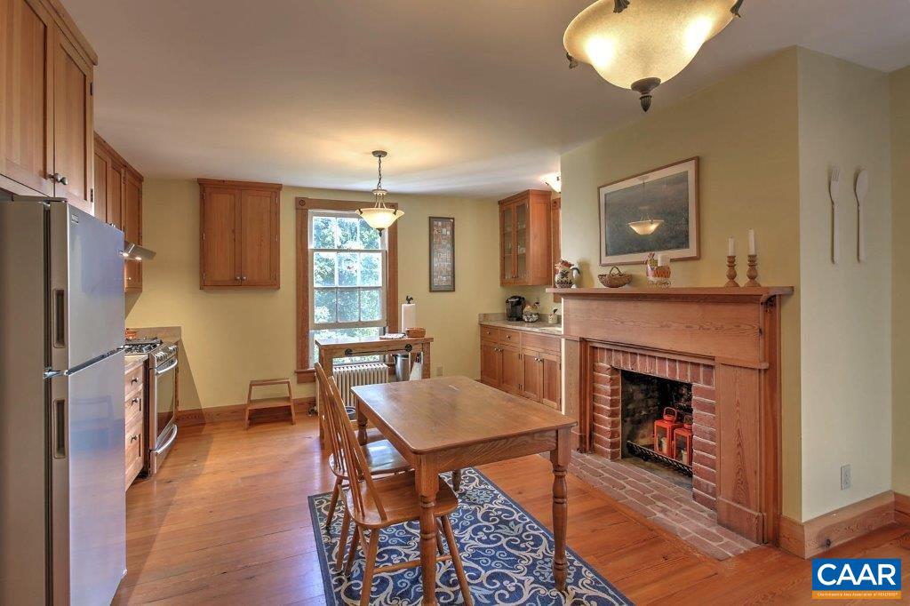 528 Top Ridge Road Stanardsville, VA 22973 - Photo 14 of 45 a dining room with furniture and a fireplace
