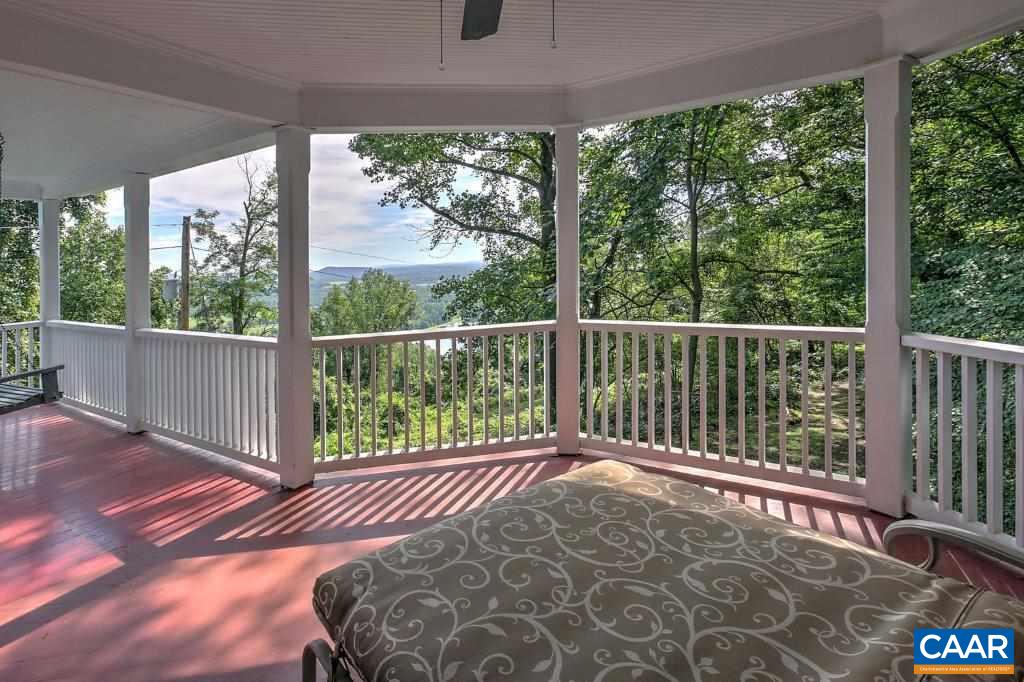 528 Top Ridge Road Stanardsville, VA 22973 - Photo 26 of 45 a view of a balcony with a floor to ceiling window and wooden floor