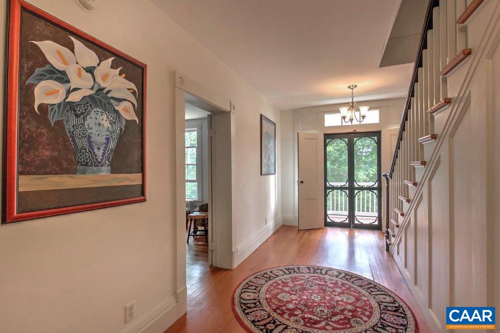 528 Top Ridge Road Stanardsville, VA 22973 - Photo 10 of 45 a view of a hallway with wooden floor and a rug