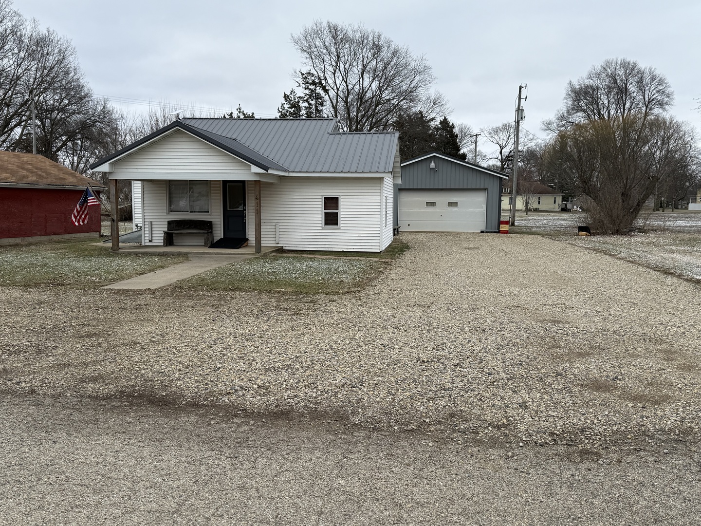 411 Jefferson Street Henry, IL 61537 - Photo 1 of 17 a view of house with wooden fence and large trees