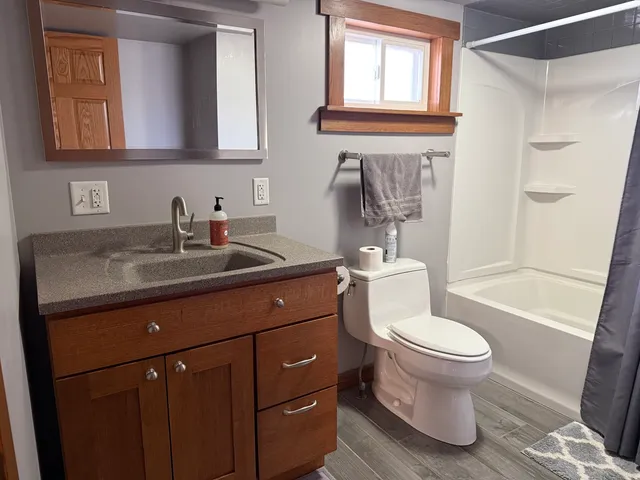 a bathroom with a sink toilet and shower