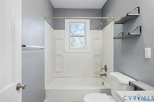 a bathroom with a bathtub and a toilet